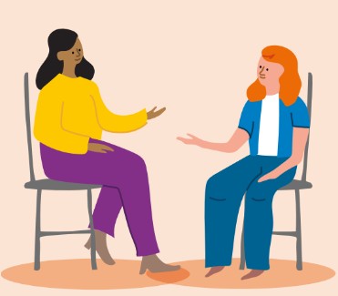 Two people sitting talking.